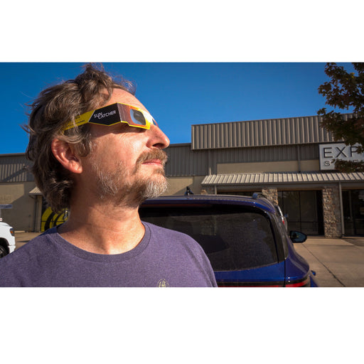 Man looking at the sun while wearing Sun Catcher solar glasses